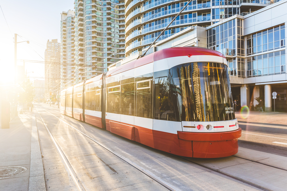 toronto tram seen from the front, with glass buildings in the background